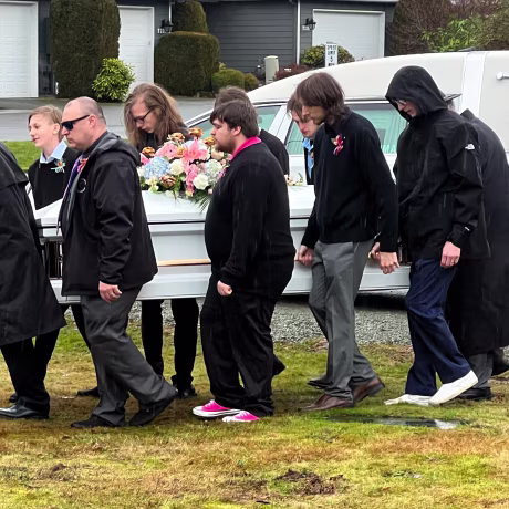 Image: Pallbearers carry Taylor Goodridge's casket at her funeral.