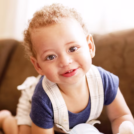 Baby boy smiling at the camera