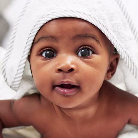 Shot of an adorable baby boy wearing a hoody towel