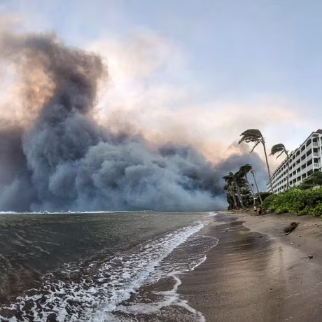 Smoke billows near Lahaina as wildfires driven by high winds destroy a large part of the historic town of Lahaina, Hawaii, on Aug. 9, 2023.