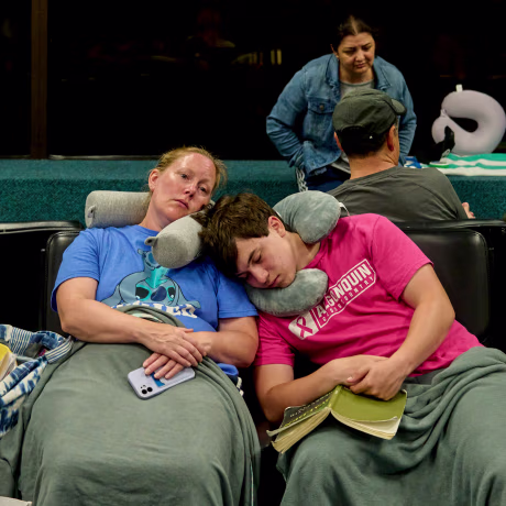 People waiting for departing flights at Kahului Airport on the Hawaiian island of Maui, where at least three wildfires have been raging, in Kahului on Wednesday, Aug. 9, 2023.