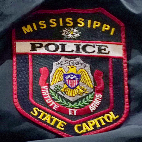 Aclose-up of a Mississippi State Capitol Police badge.