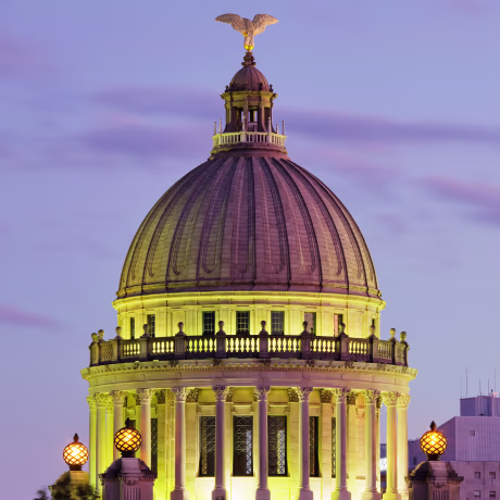 The State Capitol dome illuminated at night in Jackson, Miss.