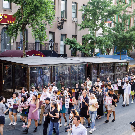People march during a vigil for Julio Ramirez in the Hell's Kitchen neighborhood of New York on June 8, 2022.