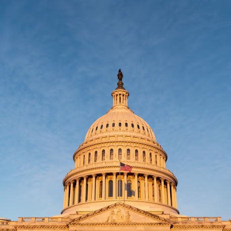 The U.S. Capitol dome is lit by the morning sun