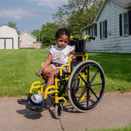 Skye McBride sits in a wheelchair outdoors