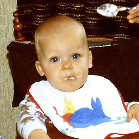 Young mother feeding her baby boy c. 1980's.