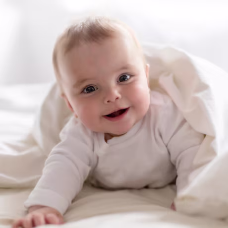 7 month baby girl smiling.