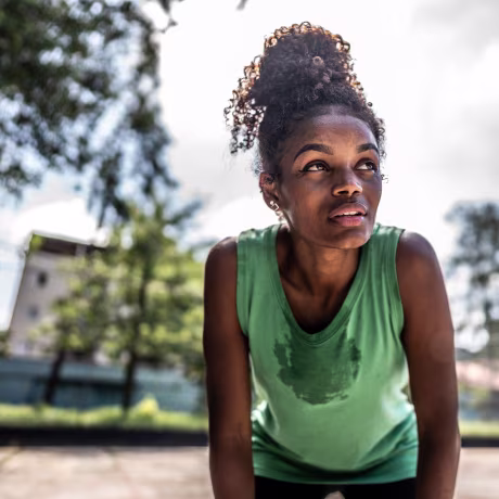 Tired young woman in a sports court