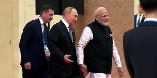 Putin and Modi hold hands ahead of meeting with Xi
