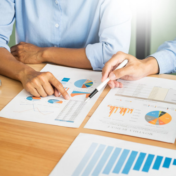 Cropped Image Businessmen Pointing At Graph In Office