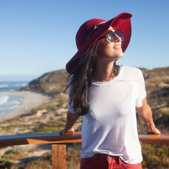 Image: Young woman in sunhat at beach lookout Australia