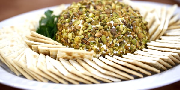 Scoop of salted pistachio crusted cream cheese with saltines