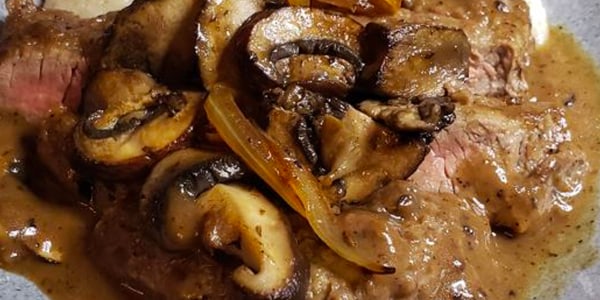 Smothered Steak and Mushrooms Over Creamy Grits