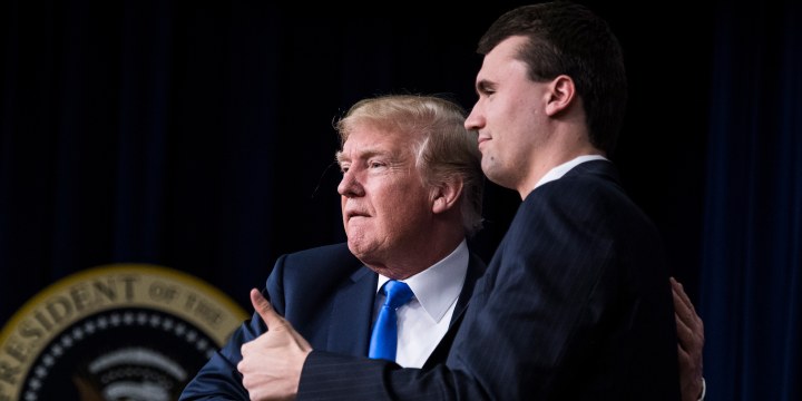 Donald Trump shakes hands with and hugs Charlie Kirk