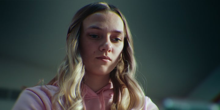 Lauryn Licari looks down at a cellphone