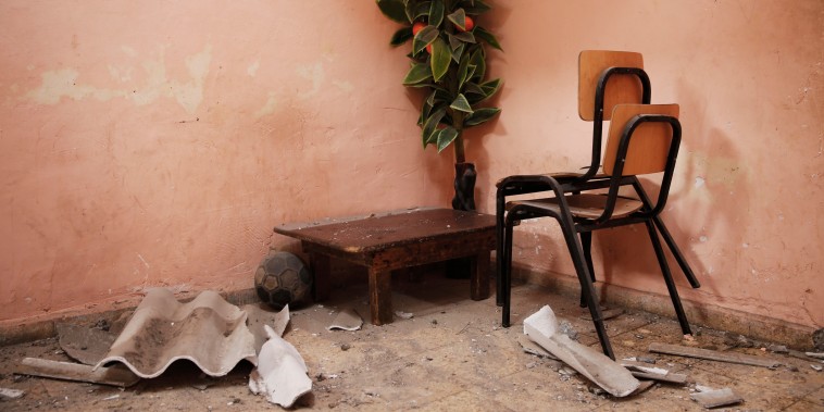 A plastic fruit tree stands in the corner of a room of a damaged home in the northern Gaza Strip
