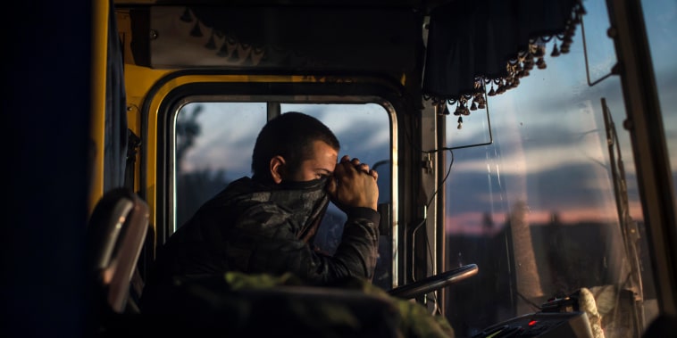 A driver sits inside a bus during an exchange of prisoners-of-war (POWs) near Donetsk, eastern Ukraine