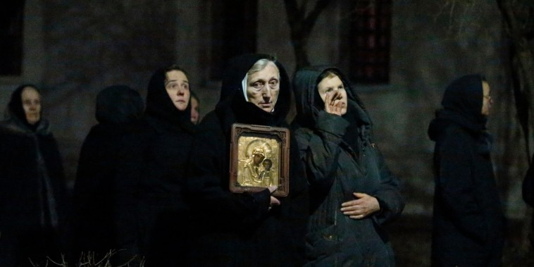 Orthodox nuns watch firefighters work to extinguish a fire at the bell tower of Novodevichy monastery, a UNESCO World Heritage site, in Moscow