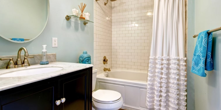Aqua bathroom with dark floor and tile wall trim. View of bathroom vanity with mirror; Shutterstock ID 197681846; PO: today.com