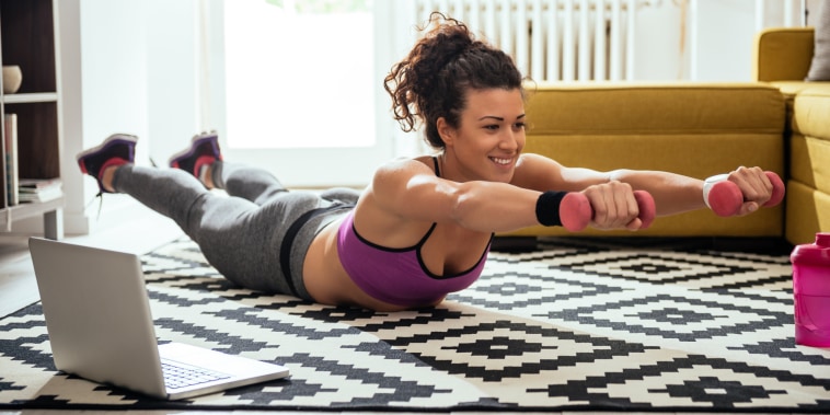 Image: Woman working out at home with computer