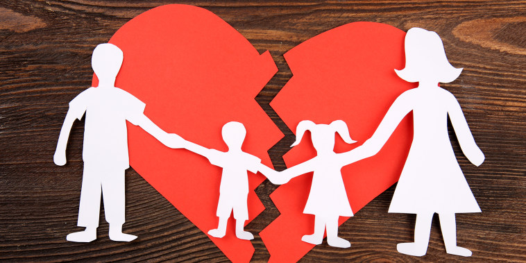 Paper cutout silhouette of a family split apart on a paper heart, divorce concept; Shutterstock ID 339672191; Purchase Order: -
