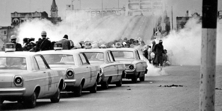 FILE - In this March 7, 1965 file photo, clouds of tear gas fill the air as state troopers, ordered by Gov. George Wallace, break up a demonstration march in Selma, Ala., on what became known as \"Bloody Sunday.\" The incident is widely credited for galvanizing the nation's leaders and ultimately yielded passage of the Voting Rights Act of 1965.