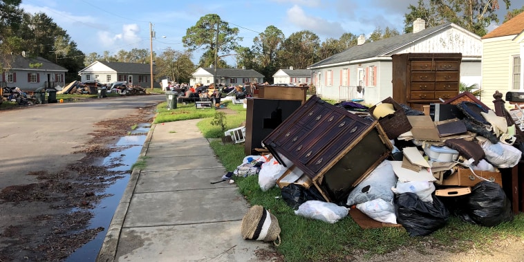 Residents in New Bern, North Carolina, drag their belongings damaged by Hurricane Florence to the side of the road on Sept. 27, 2018.