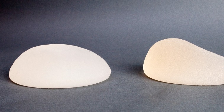 Close-up of lopsided breast implants on a table