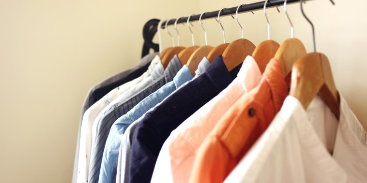 Image: Open wardrobe is usually adapted for a small living space. The shirts, dresses or coats are hanged on a clothing rail,