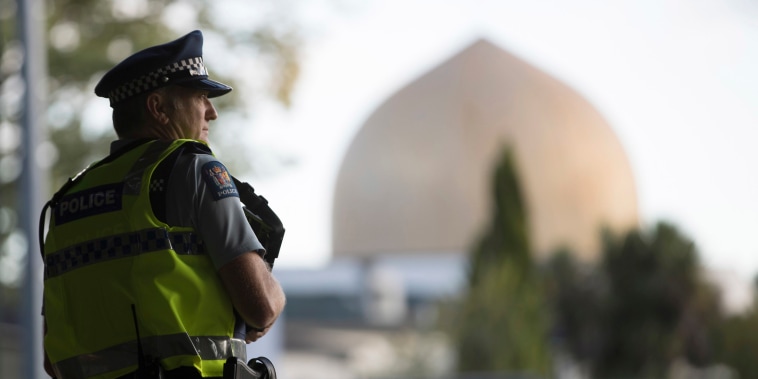 Image: A police official stands guard in front of the Al Noor mosque in Christchurch, New Zealand