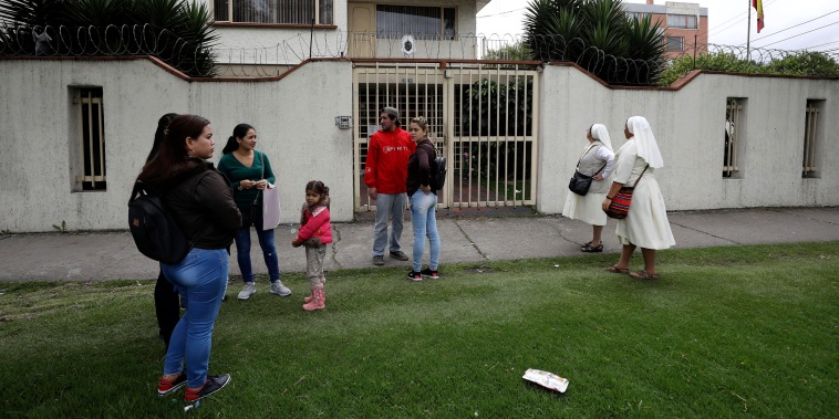 Image: Venezuelan citizens stand outside the closed consulate in Bogota, Colombia, on March 19, 2019.