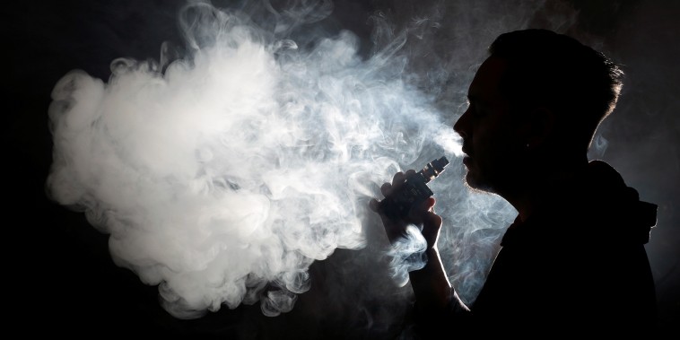 Image: A man poses for a picture, as he vapes at home in Ciudad Juarez