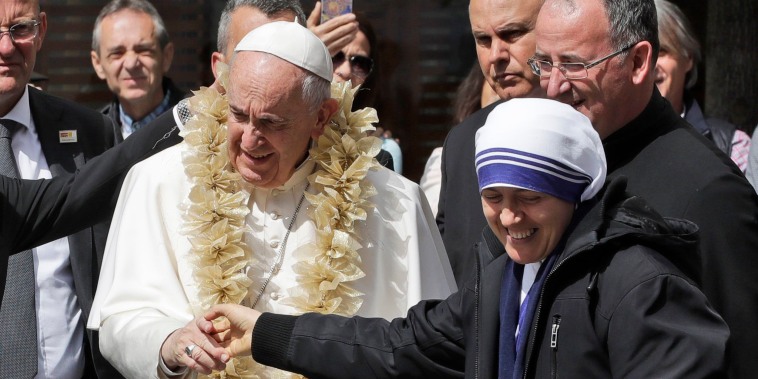 Image: Pope Francis is welcomed by a nun as he arrives at the Mother Teresa memorial in Skopje, North Macedonia