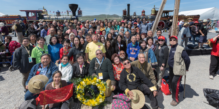 Railroad worker descendants, veterans, volunteers, and attendees pose during the 150 Year Transcontinental Railroad completion ceremony in Promontory, Utah.