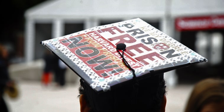Anneke Dunbar-Gronke wears a graduation cap outfitted with a sign that reads \"Make my degree prison free Harvard divest from prisons now!\"