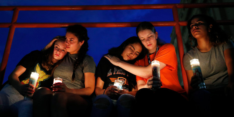 From left, Melody Stout, Hannah Payan, Aaliyah Alba, Sherie Gramlich and Laura Barrios comfort each other during a vigil for victims of the shooting Saturday, Aug. 3, 2019, in El Paso, Texas. A young gunman opened fire in an El Paso, Texas, shopping area during the busy back-to-school season, leaving multiple people dead and more than two dozen injured. (AP Photo/John Locher)