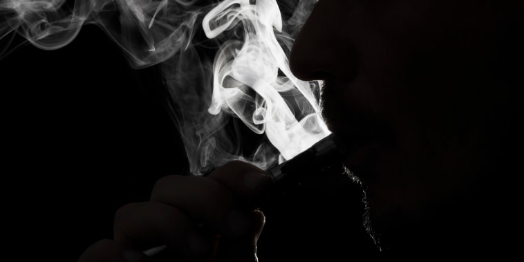 Close up photo of a person vaping e-cigarette