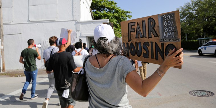 Activists march against the proposed Magic City Innovation District in the Little Haiti neighborhood of Miami on June 20, 2019. Critics say the proposed 17-acre mixed-use development would exacerbate gentrification and force out longtime residents of the neighborhood.