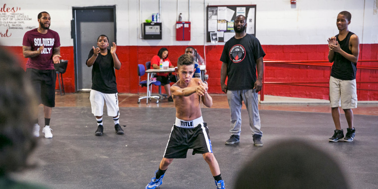 Khali Sweeney, center right, watches a student train at the Downtown Boxing Gym in Detroit.