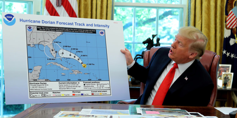 Image: UPresident Donald Trump holds an early projection map of Hurricane Dorian in the Oval Office on Sept. 4, 2019.