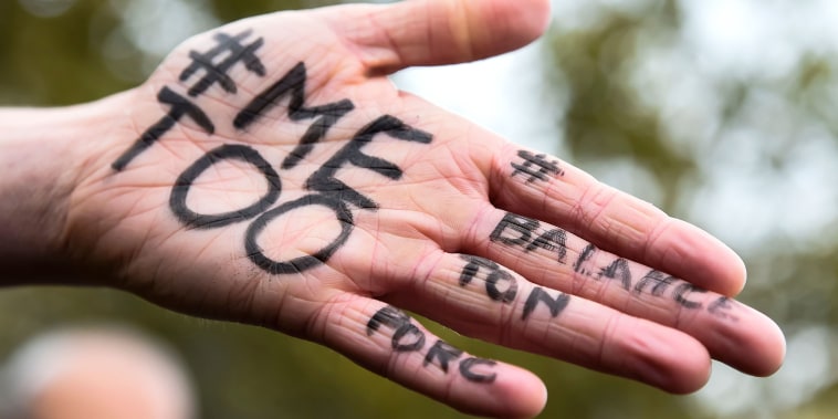 Image: The messages \"#Me too\" and #Balancetonporc (\"expose your pig\") on the hand of a protester during a gathering against gender-based and sexual violence called by the Effronte-e-s Collective, on the Place de la Republique square in Paris