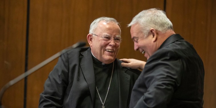 Archbishop Charles J. Chaput, left, embraces his successor Archbishop-elect Nelson J. Perez in Philadelphia on Jan. 23, 2020.