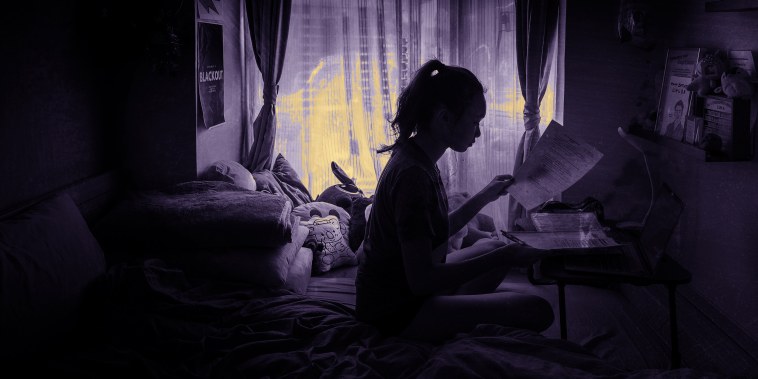 Image: Chloe Lau, a high school student in Hong Kong, does her schoolwork at home on March 4, 2020.