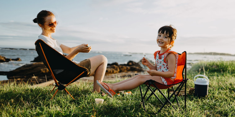 Mother and child enjoying camping by the sea