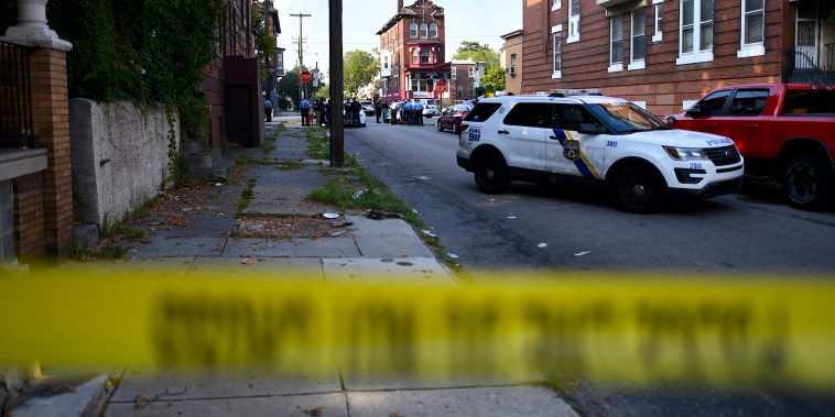 Police officers congregate while responding to a shooting in Philadelphia on Aug. 14, 2019.