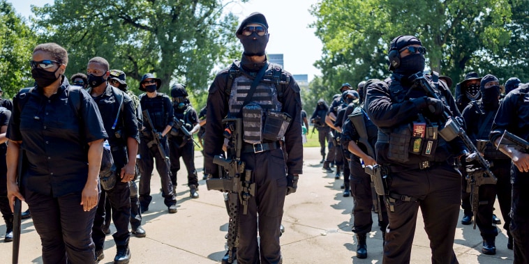 Members of NFAC hold their firearms during a march on July 25, 2020 in Louisville, Ky. The group is marching in response to the killing of Breonna Taylor.