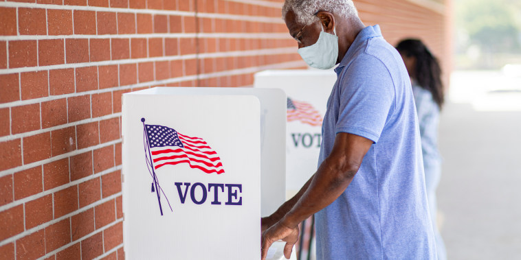 Senior Black Man Voting with a Mask