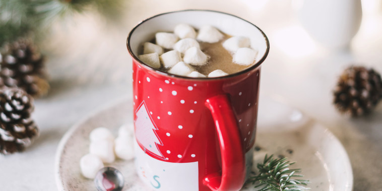 Hot cocoa with marshmallows in red Christmas cup SQUARE