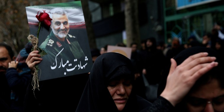 Mourners hold a photo of Gen. Qassem Soleimani in Tehran, Iran,